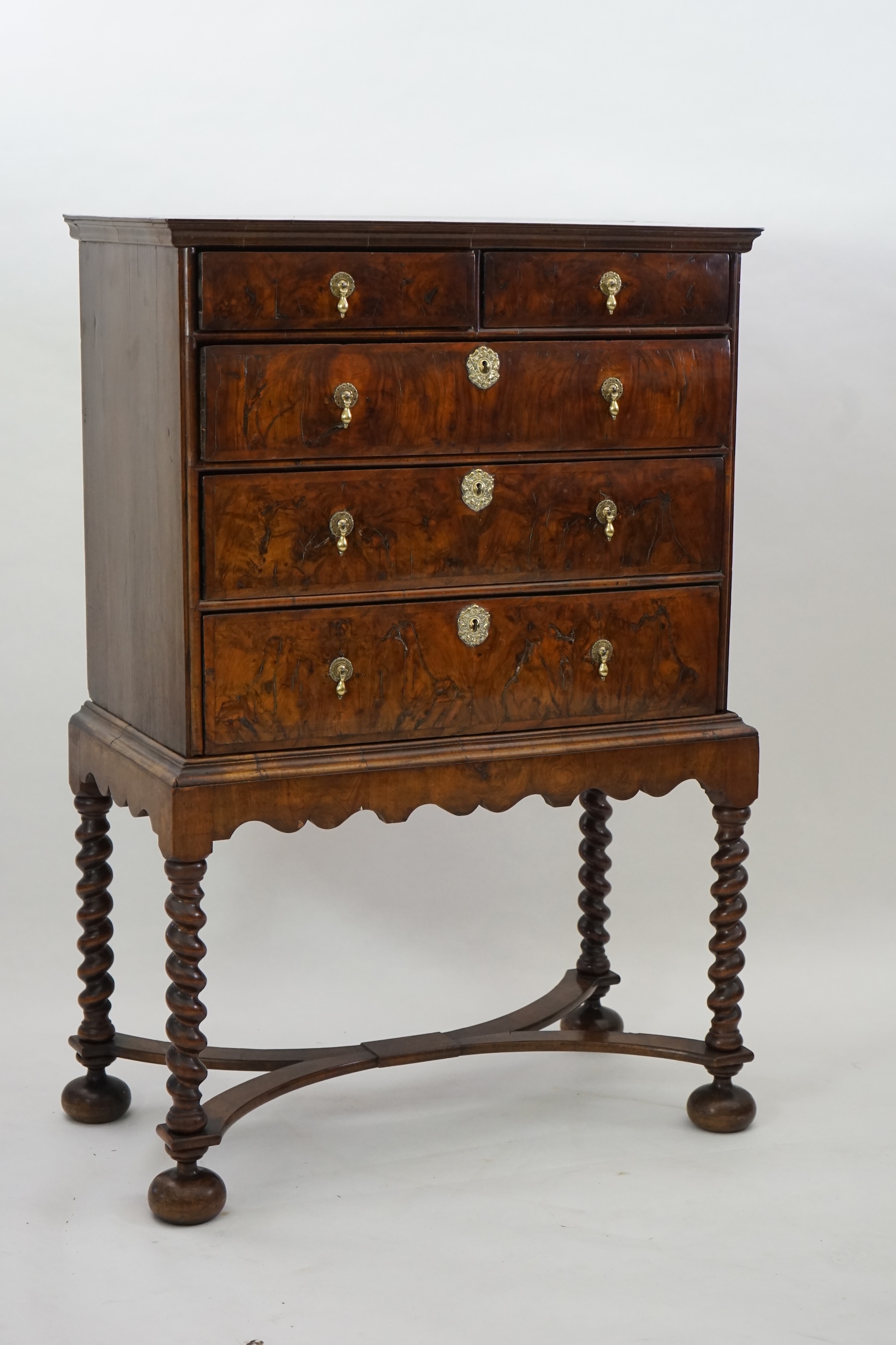 An early 18th century and later crossbanded walnut chest on stand